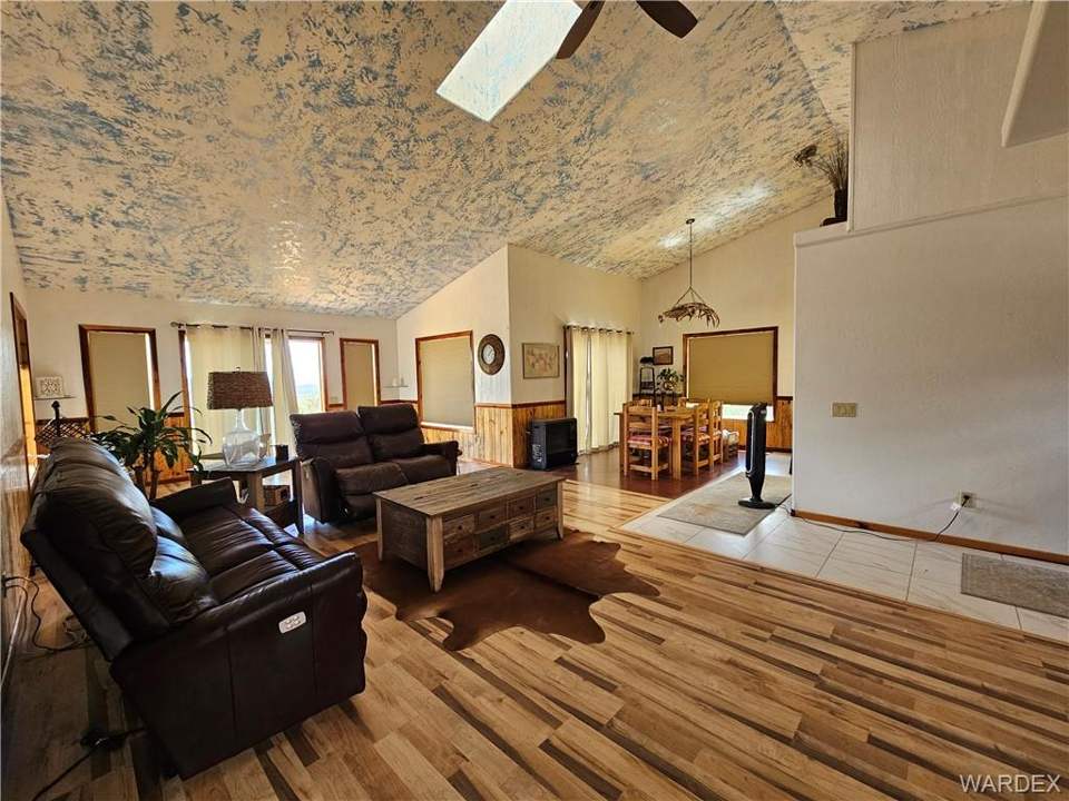 2 bed, 1 bath home on 40.96 acres in Kingman: Living room featuring light wood-style flooring, a