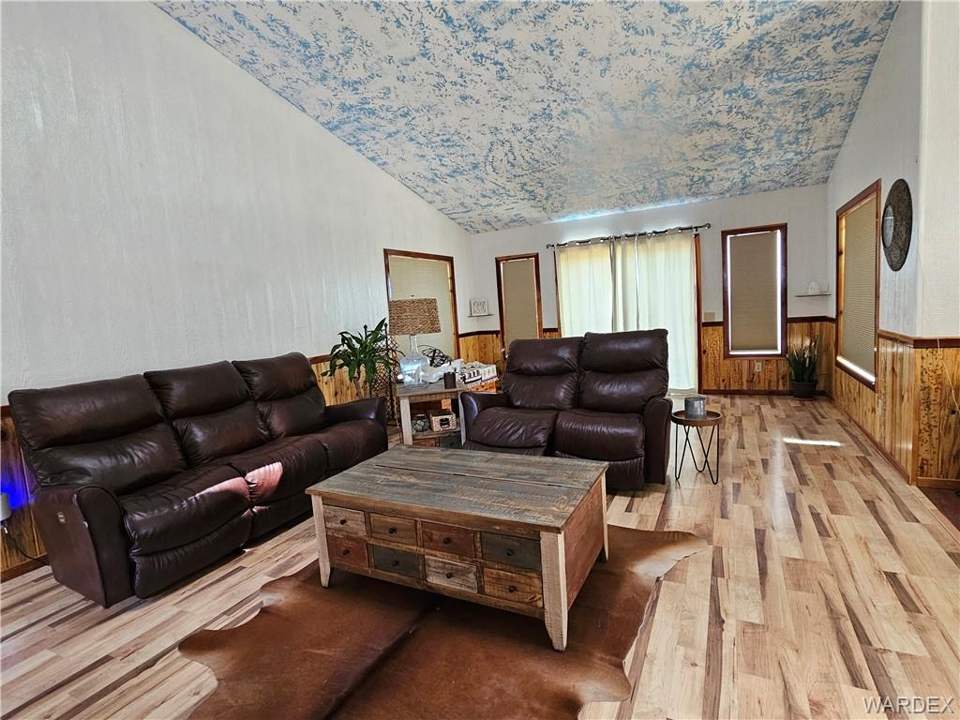 2 bed, 1 bath home on 40.96 acres in Kingman: Living area featuring vaulted ceiling, wood finish