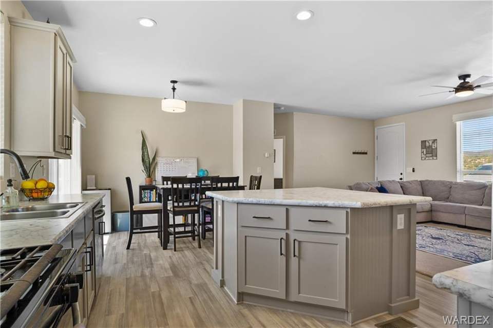 3 bed, 2 bath home in Kingman in Kingman: Kitchen with open floor plan, gray cabinets, stain