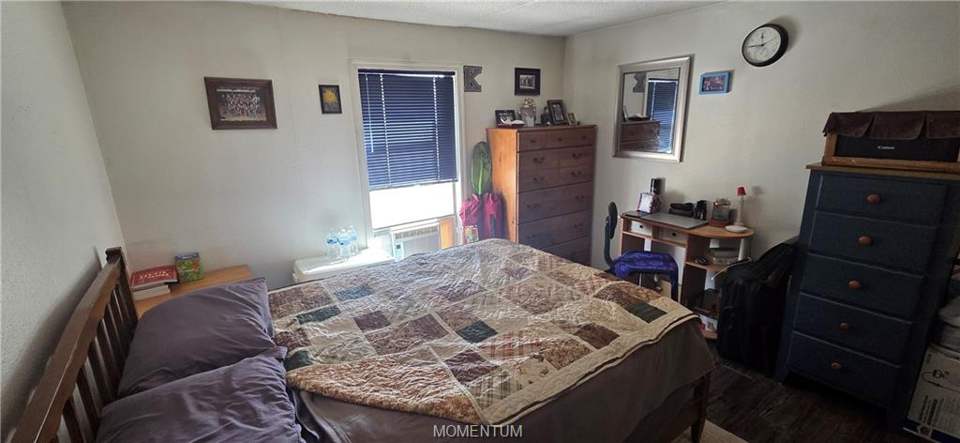 2 bed, 1 bath home on 1.18 acres in Golden Valley: Bedroom featuring dark wood-style floors