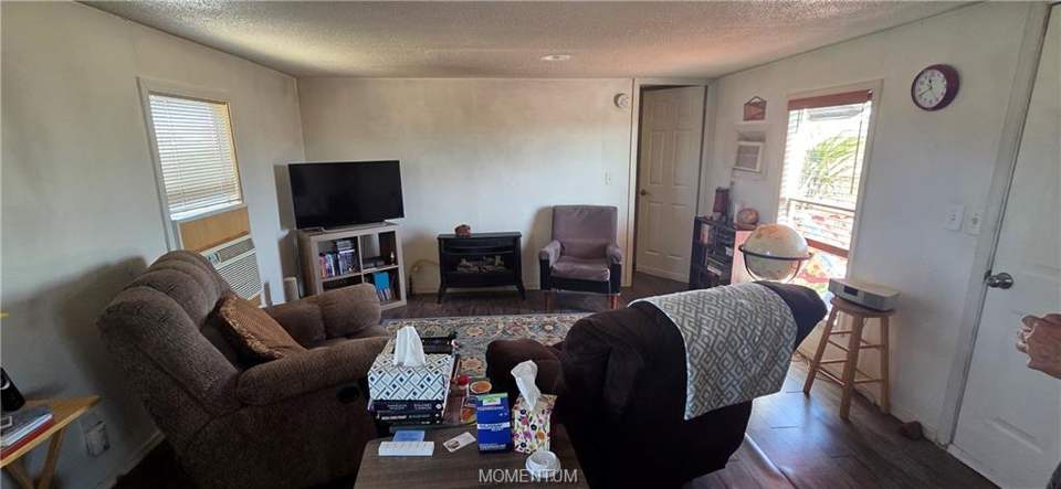 2 bed, 1 bath home on 1.18 acres in Golden Valley: Living room featuring wood finished floors and a t