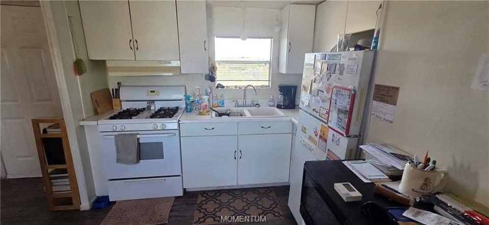 2 bed, 1 bath home on 1.18 acres in Golden Valley: Kitchen with white appliances, light countertops,