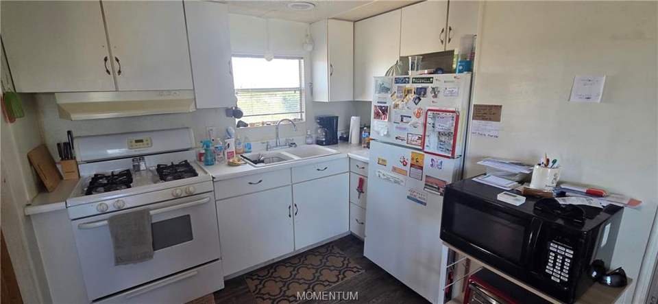 2 bed, 1 bath home on 1.18 acres in Golden Valley: Kitchen featuring white appliances, light countert