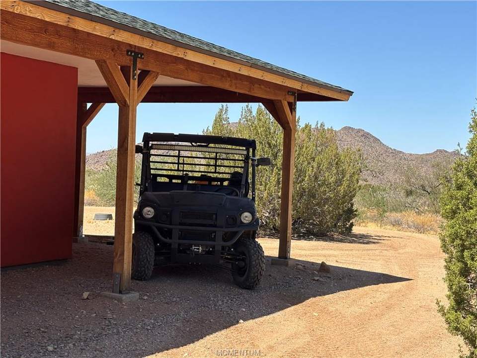 2 bed, 1 bath home on 38.55 acres in Yucca: ATV enjoys the shade of the wraparound porch too!