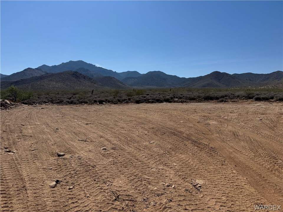 Approximately 5 acres in Dolan Springs in Dolan Springs: Expansive graded lot with a clear desert sky overh