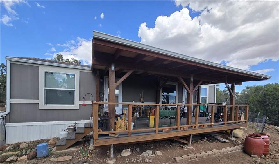 1 bed, 1 bath home on 39.4 acres in Seligman: Expansive wooden deck with an overhead cover, supp