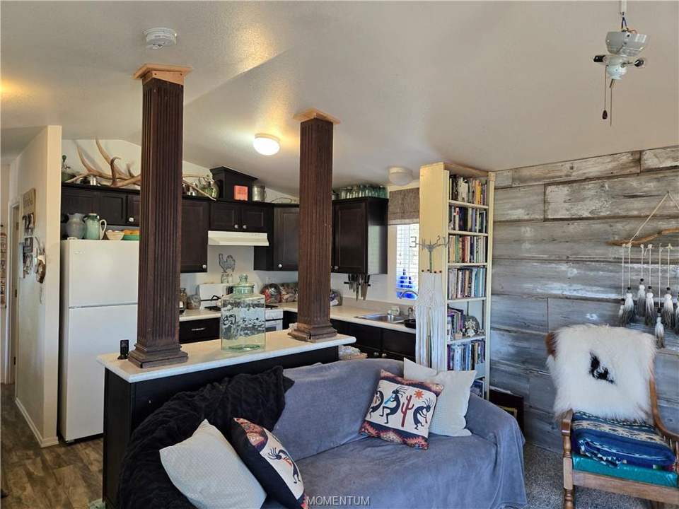 1 bed, 1 bath home on 39.4 acres in Seligman: Kitchen with dark wood-finish cabinetry, white app