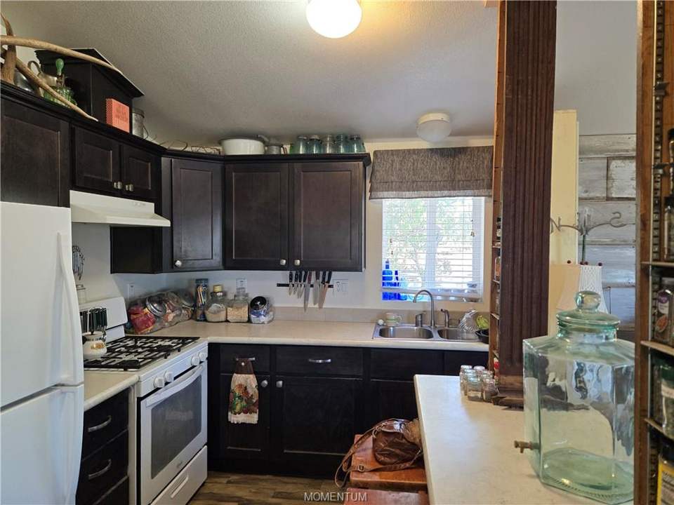 1 bed, 1 bath home on 39.4 acres in Seligman: Kitchen featuring dark wood-finish cabinetry, ligh