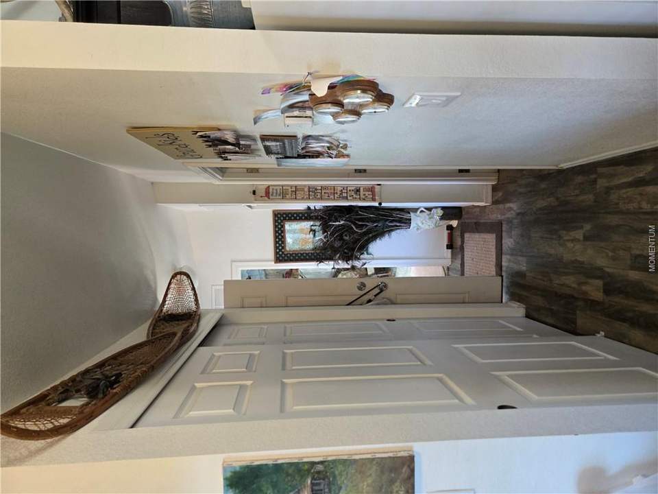 1 bed, 1 bath home on 39.4 acres in Seligman: Hallway featuring wood-finish flooring and white p